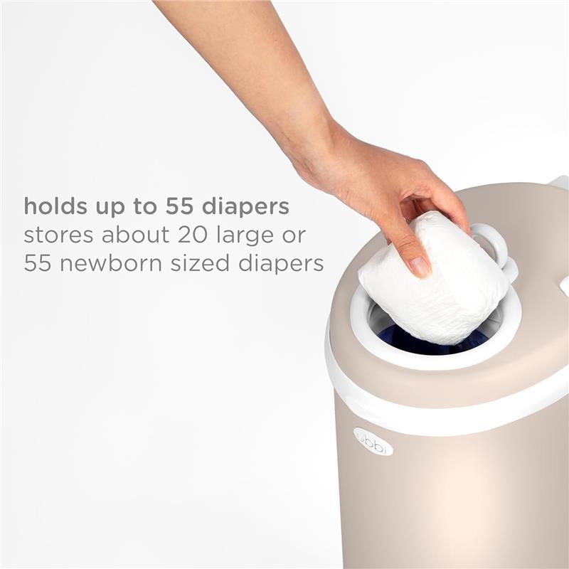 Taupe Ubbi stainless steel diaper pail with a hand placing a diaper in; states it holds up to 55 diapers.