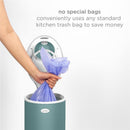 Ubbi Steel Diaper Pail featured with a hand inserting a blue trash bag, highlighting its use of standard kitchen bags.