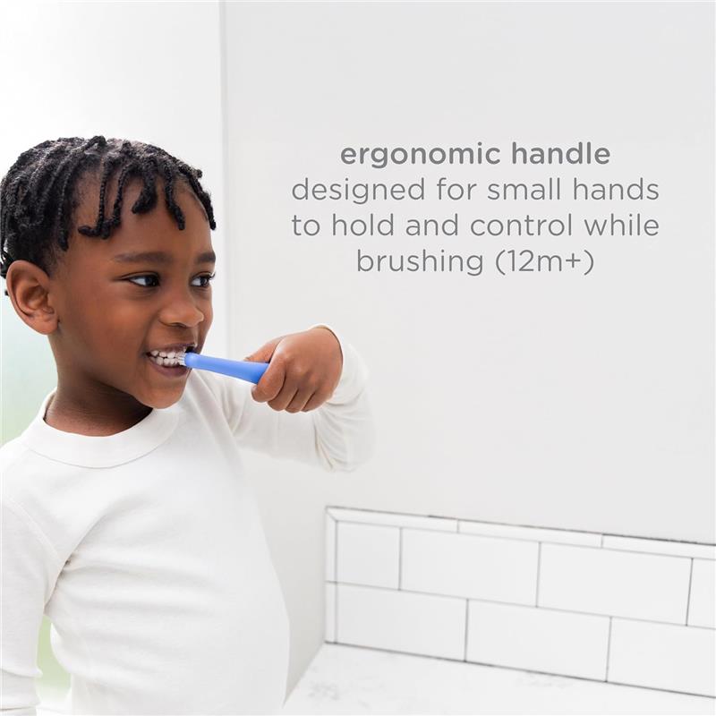 Toddler using a blue toothbrush with an ergonomic handle, designed for age 12 months and up, while brushing his teeth.
