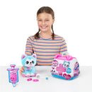 A smiling girl holds a blue and pink plush puppy toy, surrounded by a toy syringe, a pet care kit, and accessories.