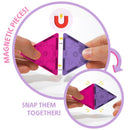 Magnetic triangular tiles in pink and purple being snapped together, showcasing the United Pacific Designs Tytan Disney Minnie Trvl kit.