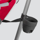 Uppababy cup holder for G-Link/G-Luxe stroller, featuring a black plastic design, attached to a metal stroller frame with a strap.