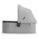 Uppababy Bassinet V3 Beau in grey chenille with a graphite frame, featuring a removable canopy and a modern design.