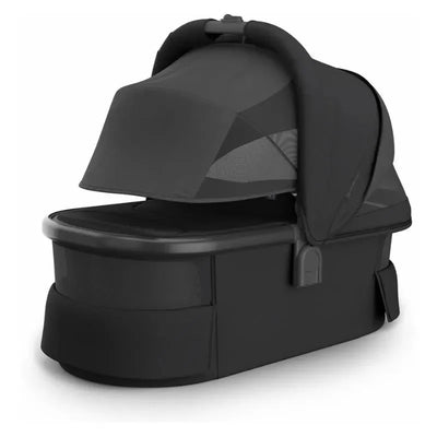 Uppababy Bassinet V3 in Charcoal with a carbon frame, featuring a covered top and mesh side panels for ventilation.