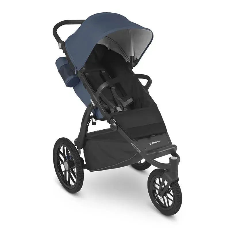 Uppababy Ridge stroller with a blue canopy, featuring adjustable seating and large rear wheels for stability.