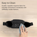 Light grey UPPAbaby Carry-All Parent Organizer made of durable neoprene, shown being wiped clean with a cloth.