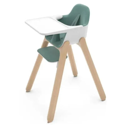 Highchair with a spruce green seat and white trim, featuring a removable tray and light wooden legs.