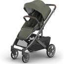Uppababy Cruz V3 Stroller in Meadow Green with Graphite Frame and Chestnut Leather handles, featuring a spacious seat and storage basket.