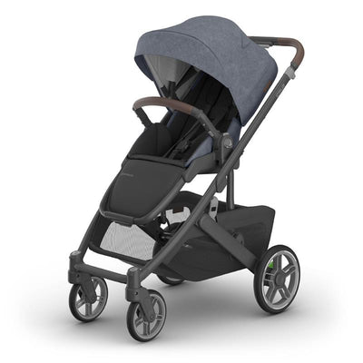 Uppababy Cruz V3 stroller in dusty blue mélange with carbon frame and chestnut leather accents.