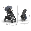Uppababy Cruz V3 stroller in dusty blue mélange with a carbon frame and chestnut leather accents, shown in both upright and folded positions.