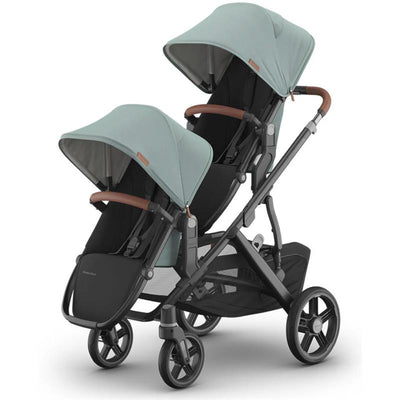 Uppababy Kenzi Vista V3 stroller in mint color with dual seats and adjustable canopies, featuring brown leatherette handles.