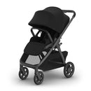 Uppababy Kona Stroller in James Black, featuring a collapsible frame, large canopy, and a spacious storage basket.