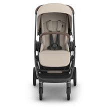 Uppababy Kona stroller in Ada (Sandstone Mélange) with an adjustable canopy and comfortable padded seat.