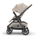 Uppababy Kona Stroller in Ada (Sandstone Mélange) with a large canopy, adjustable seat, and a sleek frame design.