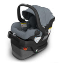 Uppababy Mesa V3 infant car seat in Stone Blue with a removable canopy and safety labels visible.