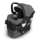 Uppababy Mesa V3 infant car seat in charcoal mélange, featuring a grey fabric seat, safety labels, and a supportive canopy.