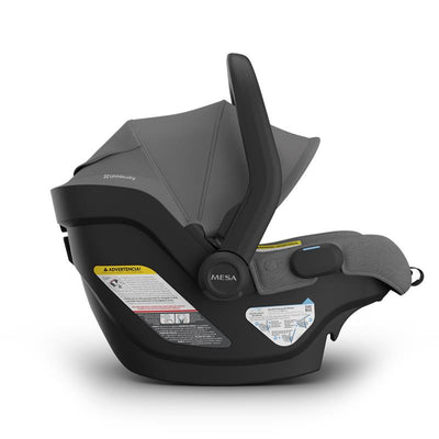 Uppababy Mesa V3 infant car seat in Greyson (Charcoal Mélange); features safety labels and a smooth ergonomic design.
