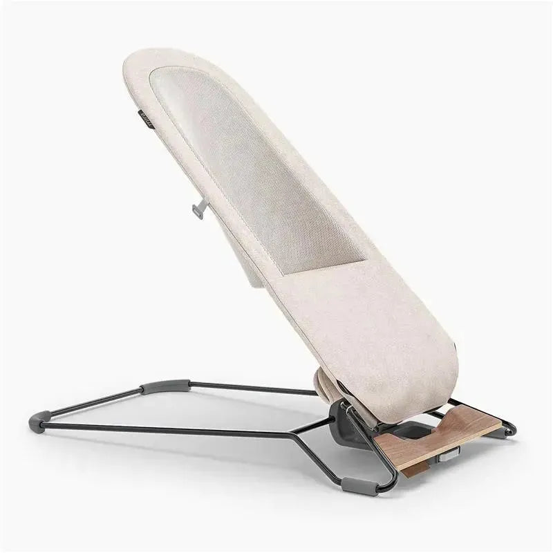 Uppababy Mira 2-in-1 bouncer and seat in sand mélange color, featuring a silver frame and birch wood base.