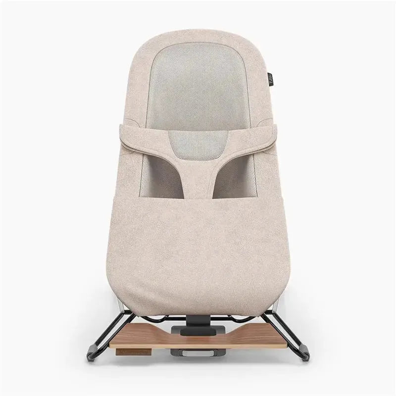 Uppababy Mira 2-in-1 bouncer and seat in sand mélange with a silver frame and birch wood base, designed for infants.