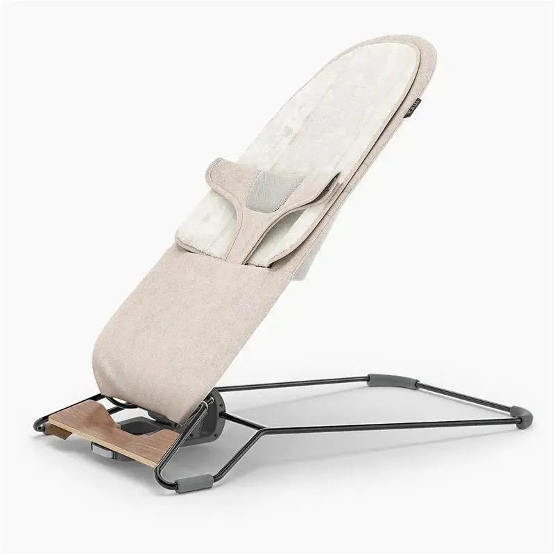 Uppababy Mira 2-in-1 bouncer and seat in sand mélange with a silver frame and birch wood base.