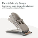 Parent-facing bouncer with three adjustable recline levels, featuring a soft grey fabric and a wooden base.