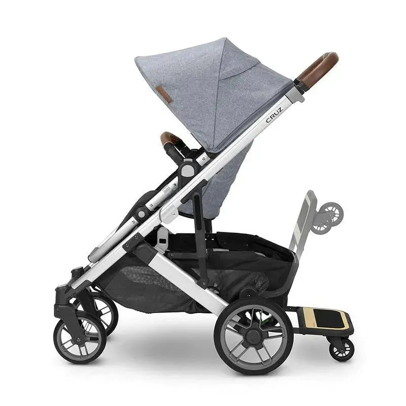 Uppababy Cruz V2 stroller with a grey canopy and attached Piggyback board for older children.
