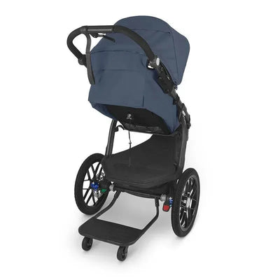 Uppababy Piggyback for Ridge, a navy blue stroller with a large canopy, empty seat, and a rear standing board for a child.