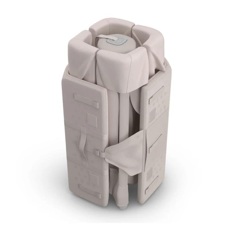 UPPAbaby Remi V2 Playard in Townsend Beige, compactly folded for storage, showcasing its soft knit fabric and secure straps.