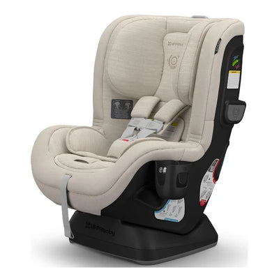 Uppababy Rove Convertible Car Seat in Kavneer (Almond Mélange) with safety labels and adjustable harness system.