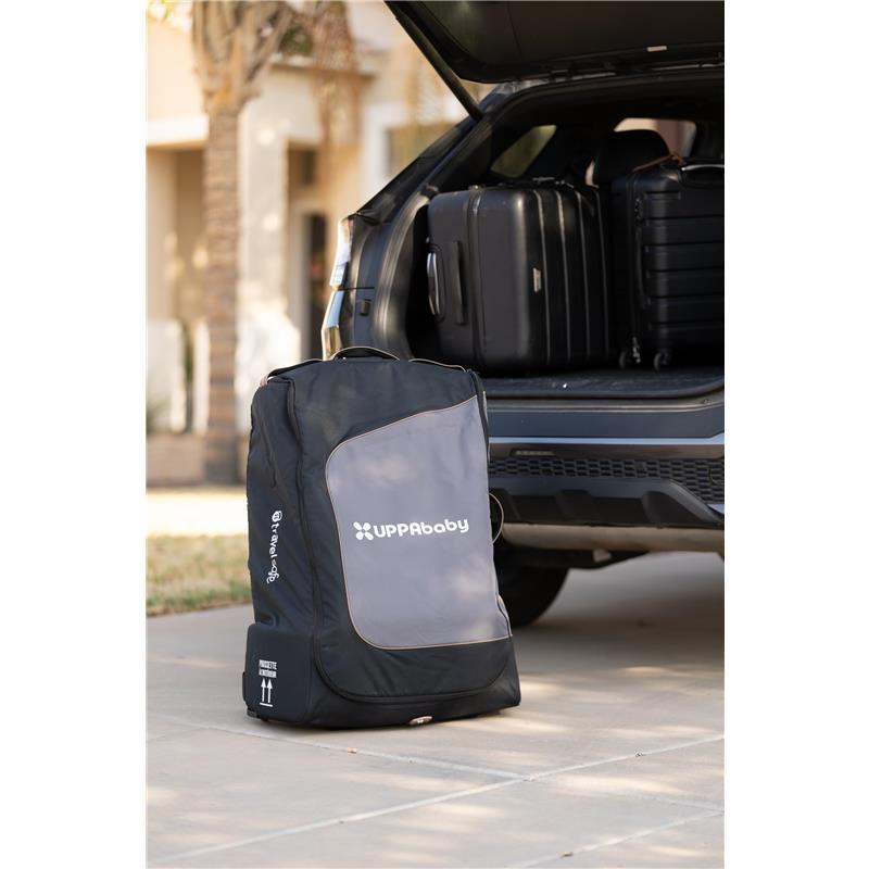 UPPAbaby Travel Bag for Vista and Cruz Strollers, designed for easy transport, shown beside a car with luggage.