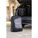 UPPAbaby Travel Bag for Vista and Cruz Strollers, designed for easy transport, shown beside a car with luggage.