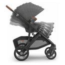 Uppababy Vista V3 stroller in Greyson, featuring a charcoal mélange fabric, carbon frame, and saddle leather handle, shown in a folding position.