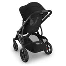 Uppababy Vista V3 stroller in black with a carbon frame and black leather accents, showcasing a spacious seat and mesh back.