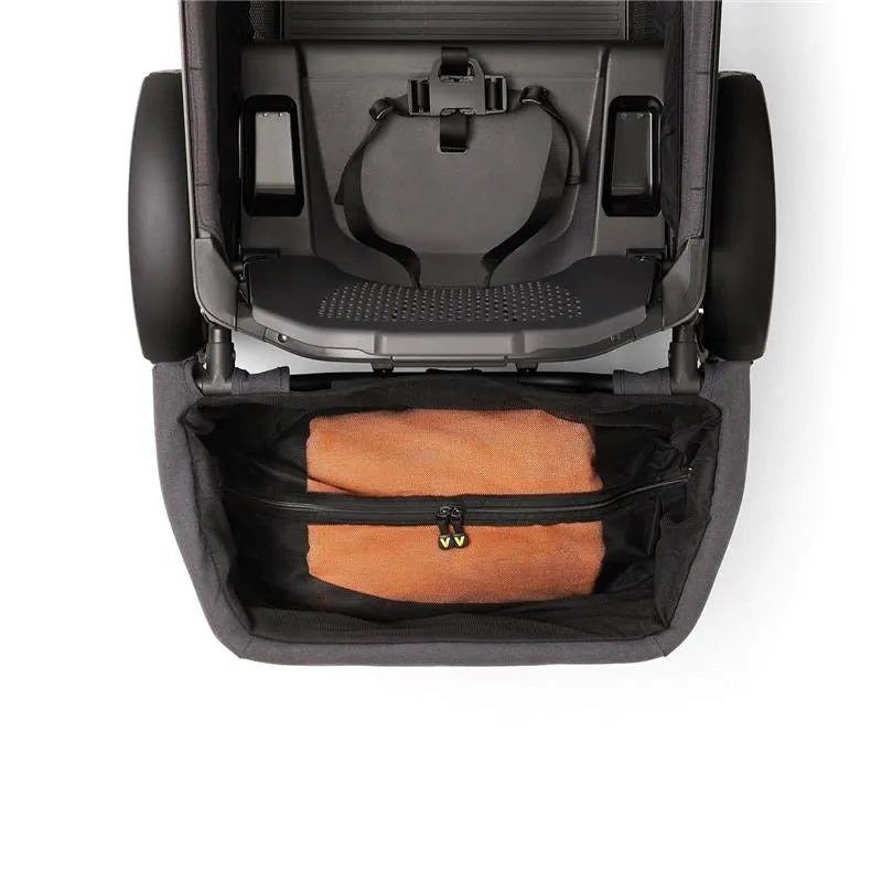 Rear foldable storage basket for Veer All-Terrain Cruiser, featuring a zippered compartment with an orange blanket inside.