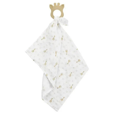 Teething ring shaped like a giraffe attached to a white swaddle with gold patterns of giraffes and stars.