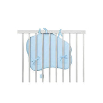 Blue Vulli Touch & Play Board secured to crib bars, featuring rounded edges and ties for safety.