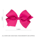 Bright pink grosgrain hair bow measuring 5 inches wide and 3 inches tall, featuring a pom-pom edge design.