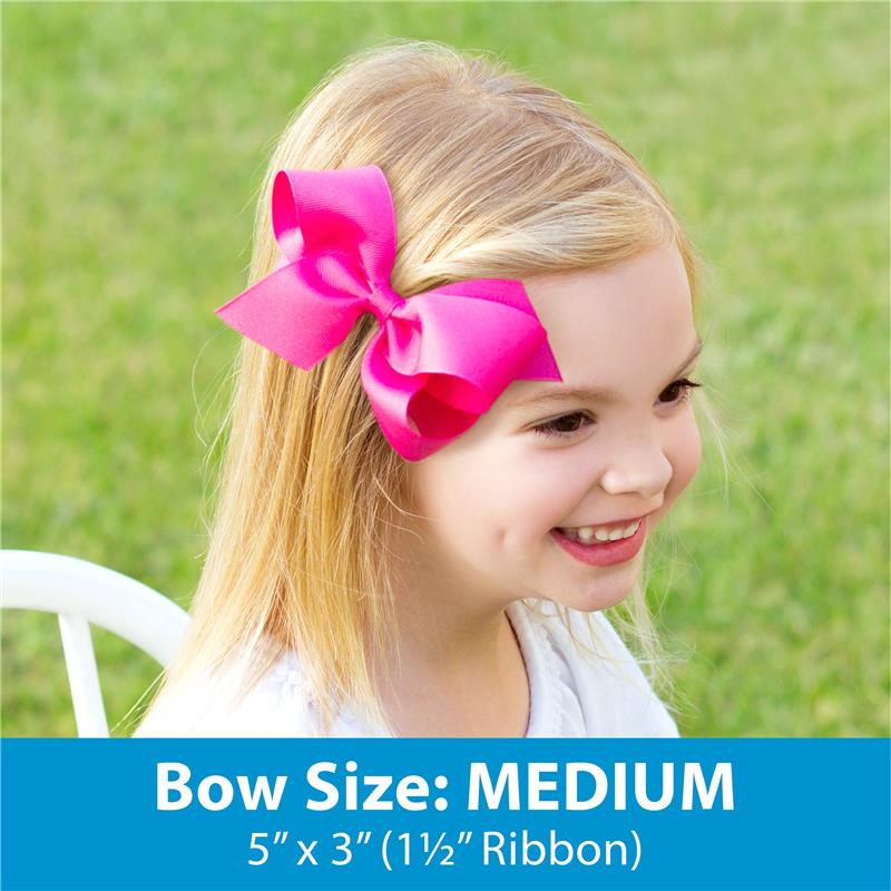 Medium red grosgrain hair bow on a young girl with light brown hair, smiling outdoors.