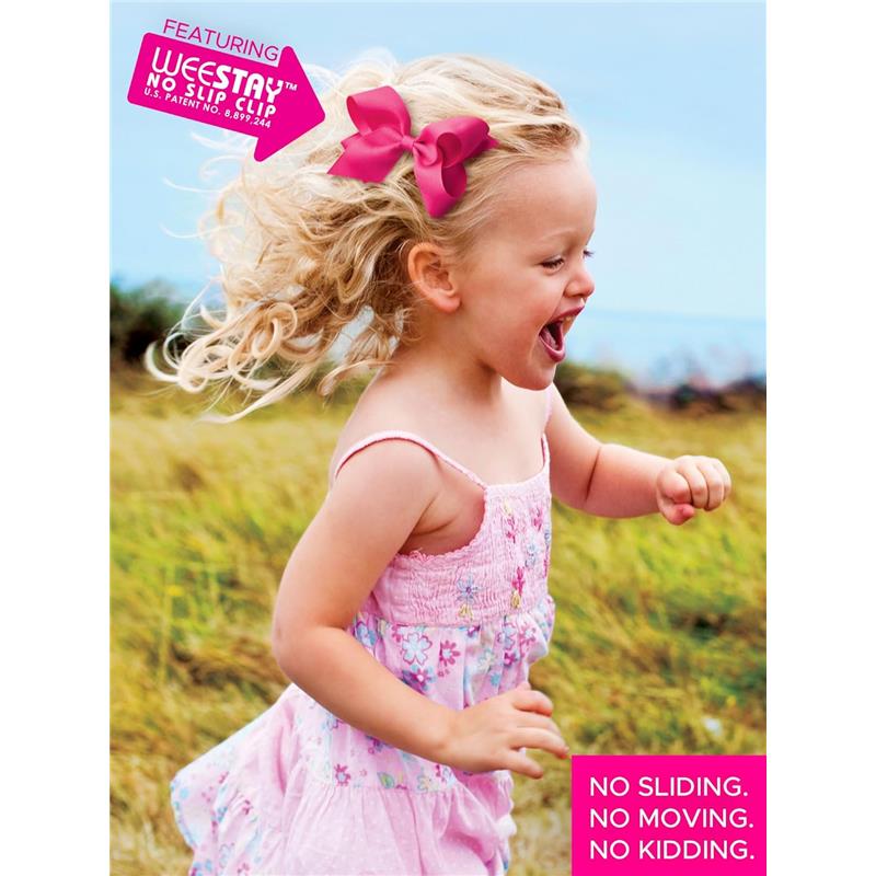 Medium antique white grosgrain hair bow with scalloped edges worn by a smiling girl in a pink dress, playing outdoors.