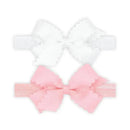 Two-pack of grosgrain bows with scalloped edges; one white and one pink, designed for girls.