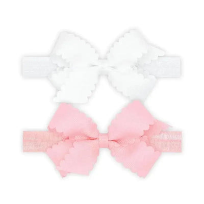Two-pack of grosgrain bows with scalloped edges; one white and one pink, designed for girls.
