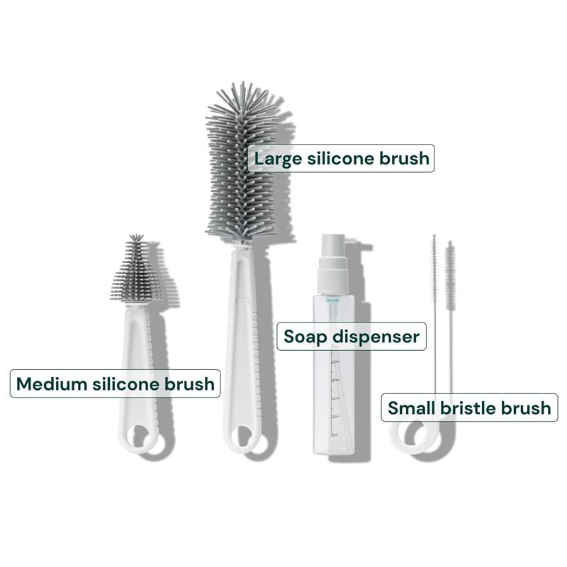 Travel cleaning kit featuring large, medium, and small silicone brushes, a soap dispenser, and a small bristle brush.