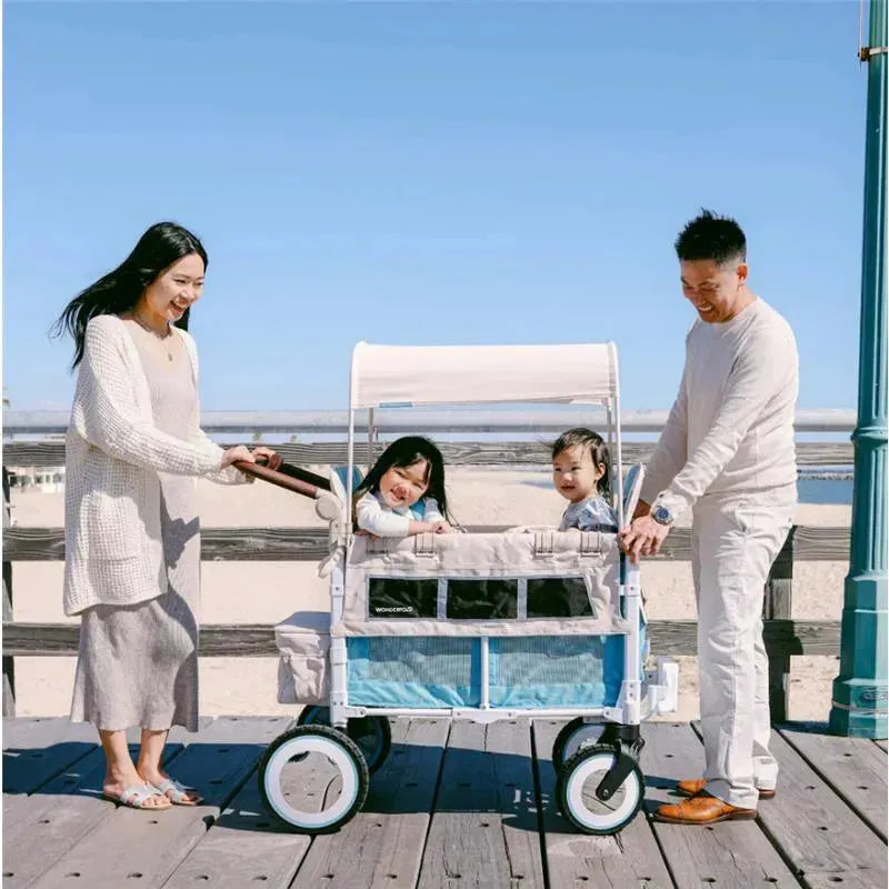 Volkswagen Special Edition WonderFold double stroller wagon in Bondi Blue, with two children being pushed by a smiling couple.