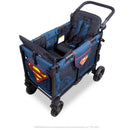 WonderFold W2 Luxe Pro double stroller wagon with a blue fabric and Superman logos, featuring two seating areas and safety harnesses.