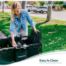 A woman cleans the Wonderfold Flex Snack Tray for W1/W2, which includes cup holders, in a park setting.
