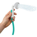 Green Yookidoo baby bath shower head designed as an elephant with a trunk spout rinsing water.