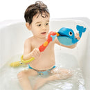 Child playing with Yookidoo Submarine Spray Whale toy in a bathtub, holding a colorful spray nozzle as water flows from the whale.