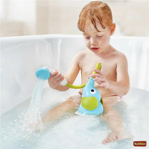 Child playing in a bathtub with the Yookidoo Elephant Baby Shower, using a detachable showerhead to squirt water.