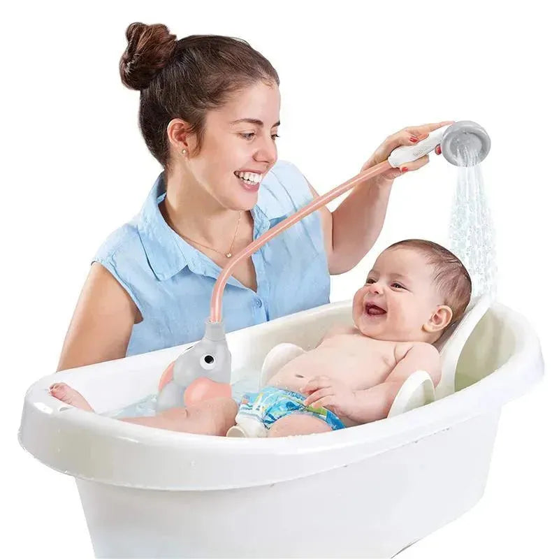 Woman joyfully bathes a baby in a white tub using a pink Yookidoo Elephant shower toy.