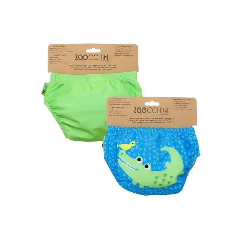 Reusable swim diaper set featuring a green solid diaper and a blue diaper with an alligator graphic.